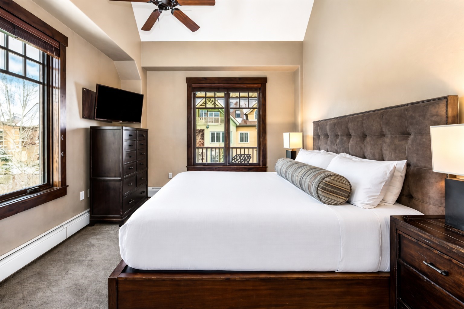 600 Columbine Road, Unit 5305 Breckenridge, CO 80424 - Photo 10 of 36 a spacious bedroom with a bed and a flat screen tv