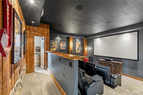 a media room with lots of chairs and a large window