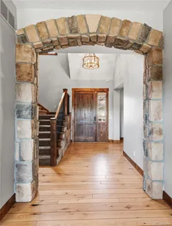 a view of a hallway with furniture and wooden floor