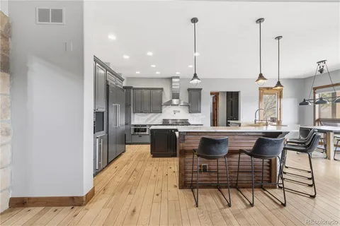 a kitchen with kitchen island a sink stainless steel appliances and cabinets