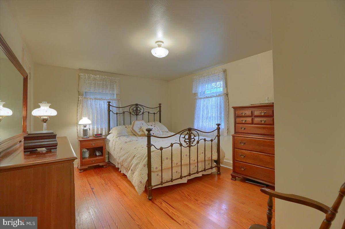 43 East Lemon Street Lititz, PA 17543 - Photo 22 of 27 a bedroom with a bed and wooden floor