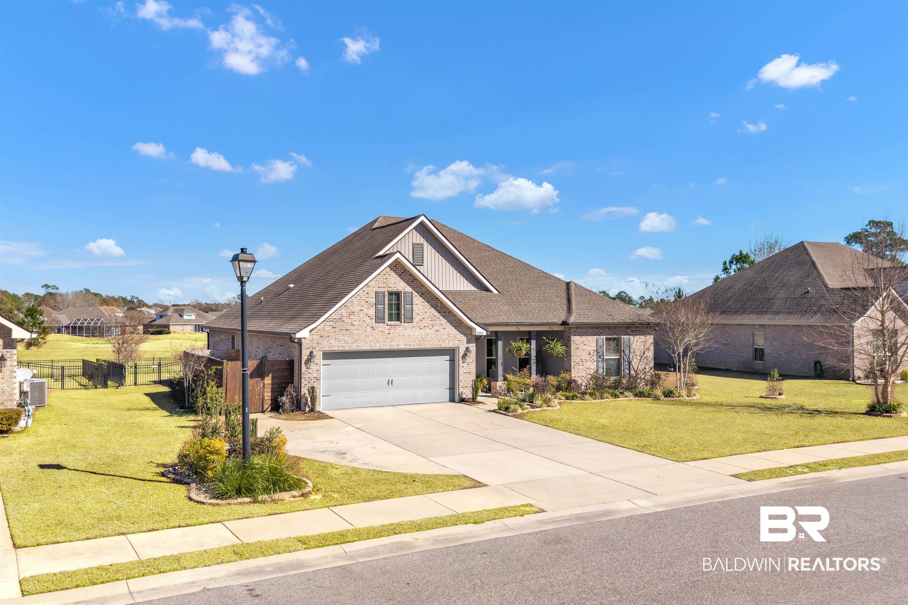 22531 Putter Lane Foley, AL 36535 - Photo 2 of 43 View of front of home with brick siding, concrete driveway, board and batten siding, and a shingled roof