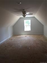 2085 Cedar Road York, SC 29745 - Photo 12 of 13 an empty room with a ceiling fan and windows