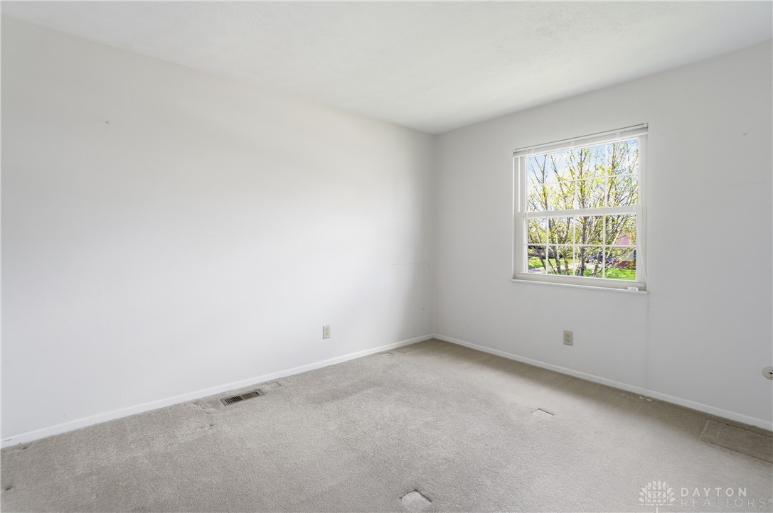 9964 Hummingbird Way Dayton, OH 45458 - Photo 36 of 57 This spacious bedroom offers ample natural light and a neutral palette, awaiting your personal touch.