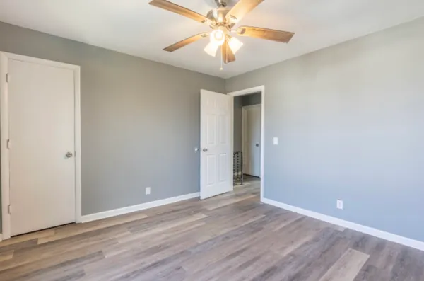a view of an empty room and wooden floor