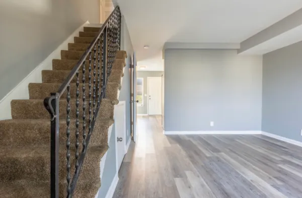 a view of a hallway with wooden floor and staircase
