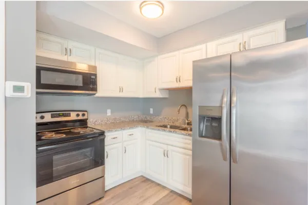 a kitchen with a refrigerator stove and microwave