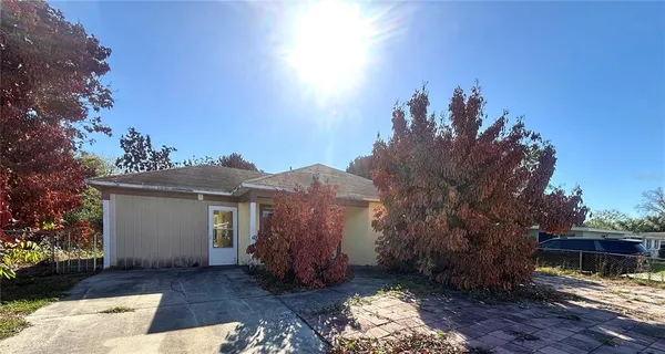 a view of a house with a yard and garage