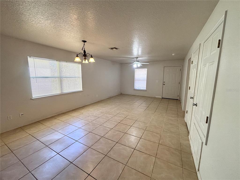 531 Carlisle Avenue Altamonte Springs, FL 32714 - Photo 3 of 18 an empty room with windows and fan
