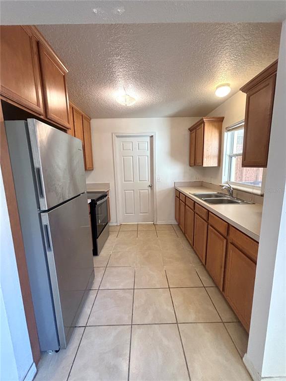 531 Carlisle Avenue Altamonte Springs, FL 32714 - Photo 5 of 18 a kitchen with stainless steel appliances granite countertop a refrigerator a sink and a stove