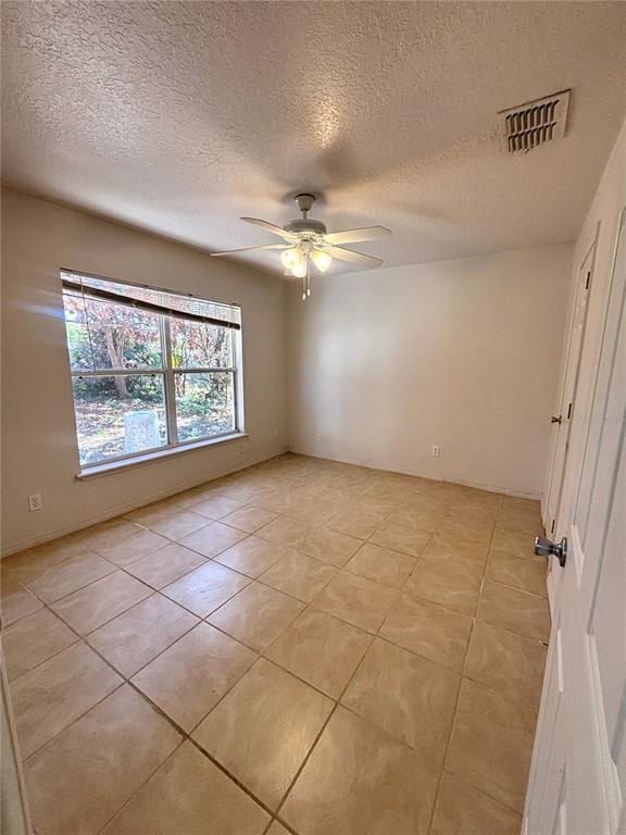 531 Carlisle Avenue Altamonte Springs, FL 32714 - Photo 6 of 18 an empty room with windows and fan