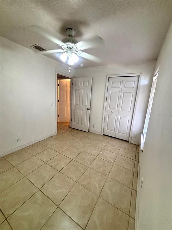 531 Carlisle Avenue Altamonte Springs, FL 32714 - Photo 9 of 18 an empty room with windows and fan