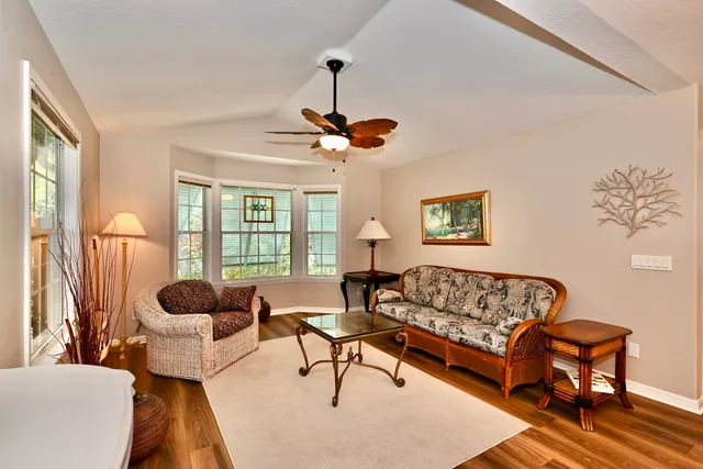 a living room with furniture a chandelier and a window