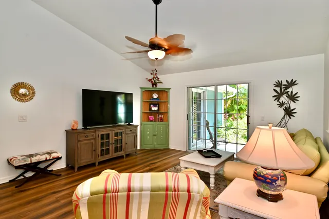 a bedroom with two beds and a flat screen tv