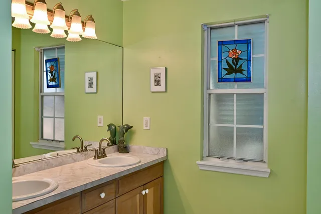 a bathroom with a sink mirror and vanity