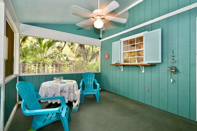 a backyard of a house with a table and chairs