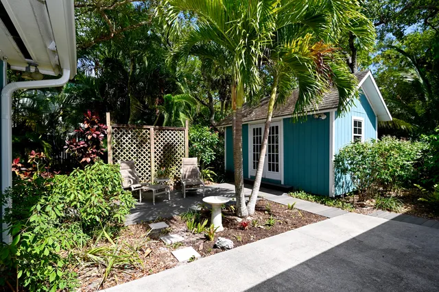 a view of a house with backyard and sitting area
