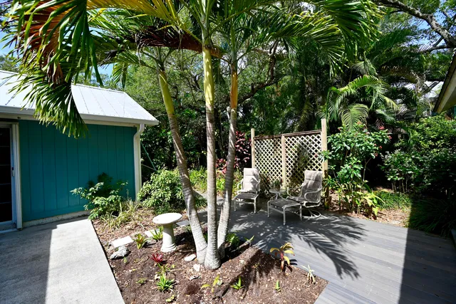 an aerial view of a house with a yard and large tree