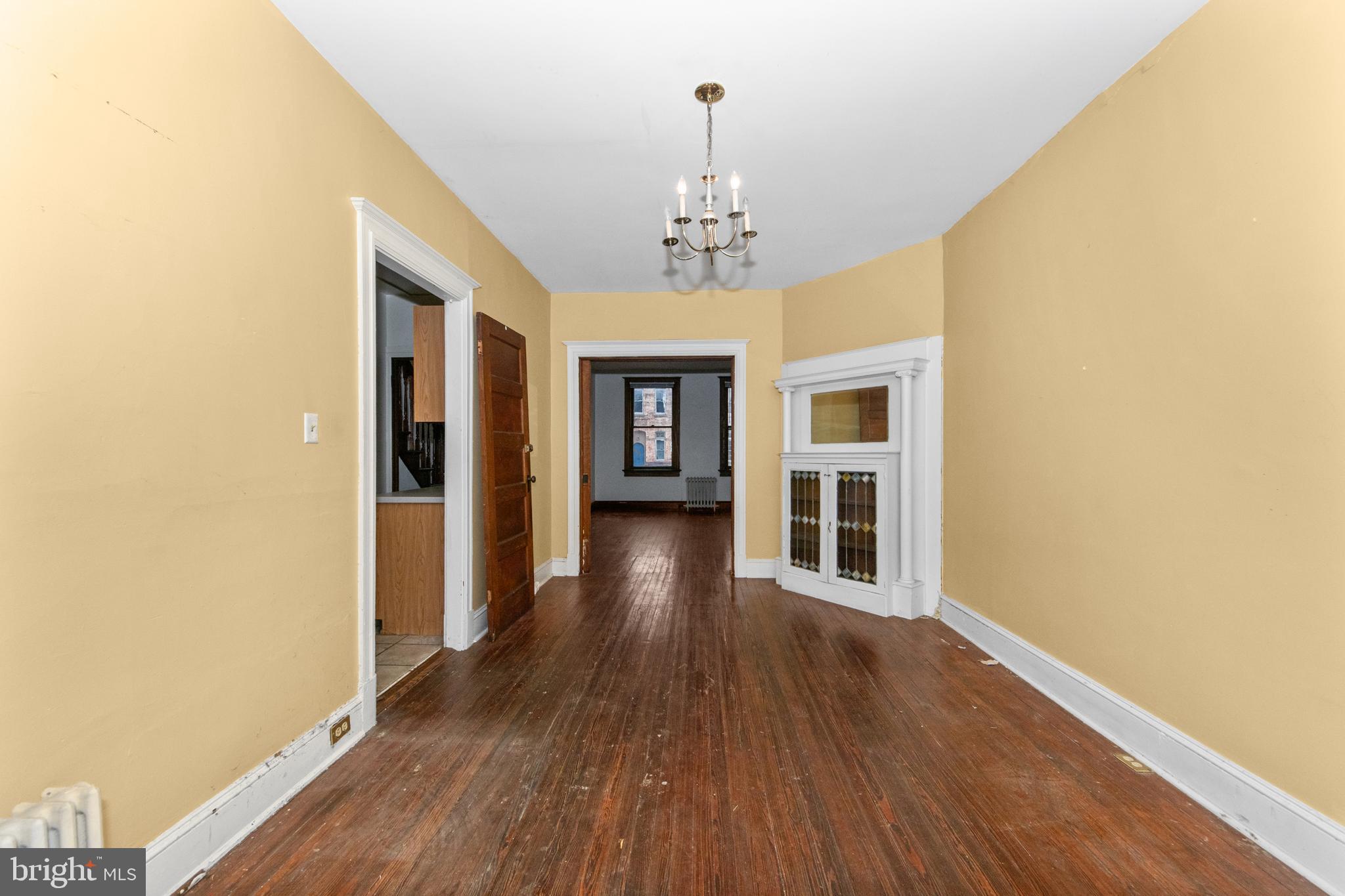 1014 Independence Avenue Southeast Washington, DC 20003 - Photo 15 of 51 a view of a hallway with wooden floor and a chandelier