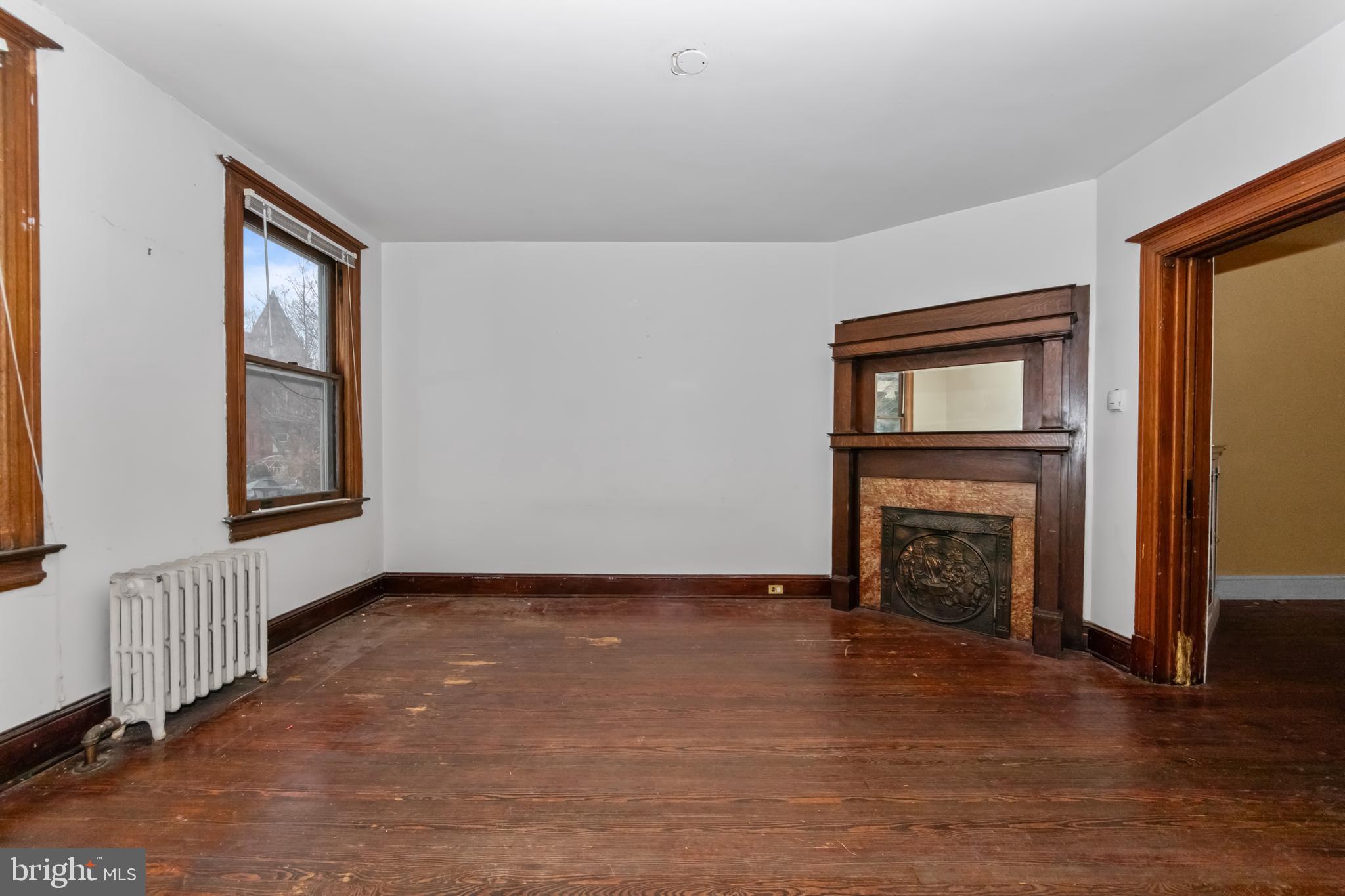 1014 Independence Avenue Southeast Washington, DC 20003 - Photo 6 of 51 an empty room with windows fireplace and wooden floor