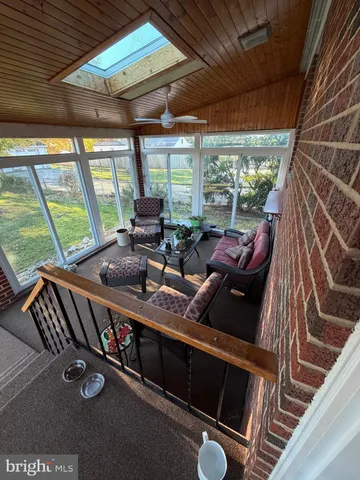 a living room with furniture a large window