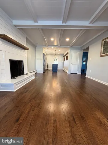 a view of a room wooden floor and windows