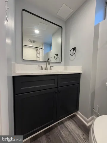 a bathroom with a sink mirror and toilet