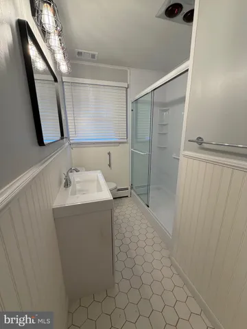 a bathroom with a sink and mirror
