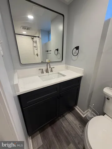 a bathroom with a sink a toilet a mirror and vanity