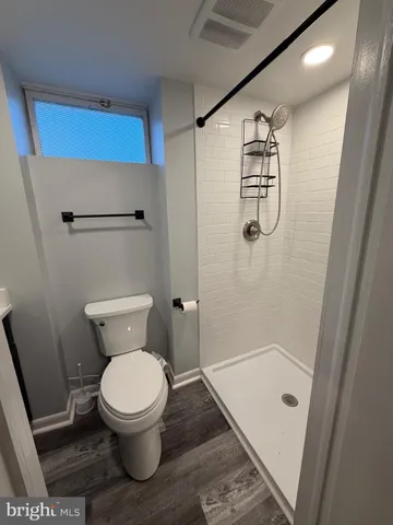 a bathroom with a toilet and a shower