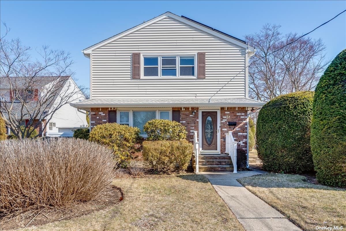 51 Wallace Drive Plainview, NY 11803 - Photo 1 of 1 a front view of a house with garden
