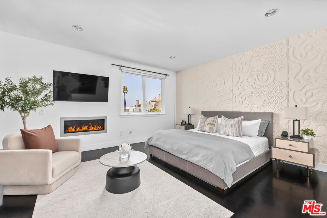 32 Galleon Street Marina del Rey, CA 90292 - Photo 11 of 24 a bedroom with a bed a couch and a fireplace