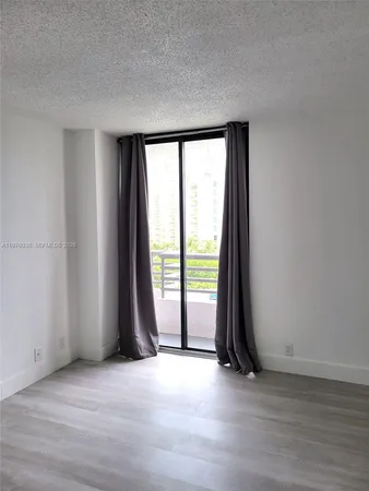 an empty room with wooden floor and a window