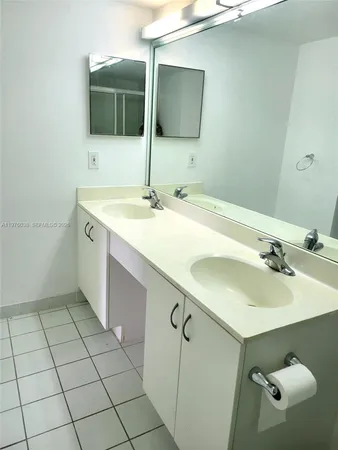 a bathroom with a sink vanity and mirror