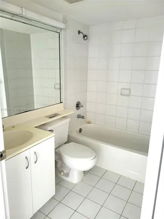 a bathroom with a sink a toilet a mirror and a bathtub