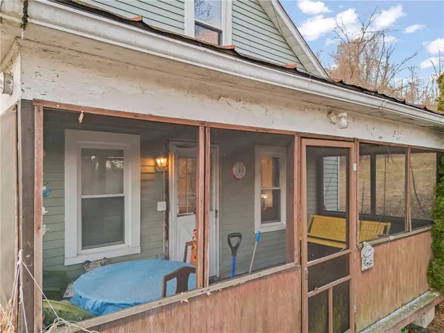 a living room with furniture a fireplace and a window