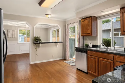 a kitchen with granite countertop a refrigerator and a sink