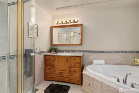 a bathroom with a bathtub sink and cabinets