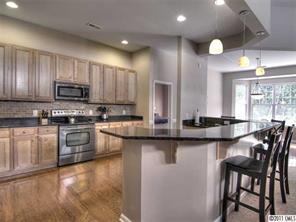 368 Sand Paver Way Fort Mill, SC 29708 - Photo 3 of 12 a kitchen with kitchen island granite countertop wooden cabinets and a refrigerator
