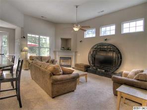 368 Sand Paver Way Fort Mill, SC 29708 - Photo 4 of 12 a living room with furniture a chandelier and a fireplace