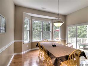 368 Sand Paver Way Fort Mill, SC 29708 - Photo 8 of 12 a view of a dining room with furniture large windows and wooden floor