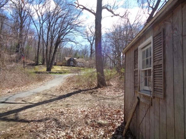 116 Maynard Road Wilbraham, MA 01095 - Photo 3 of 11 a backyard of a house with trees and wooden fence