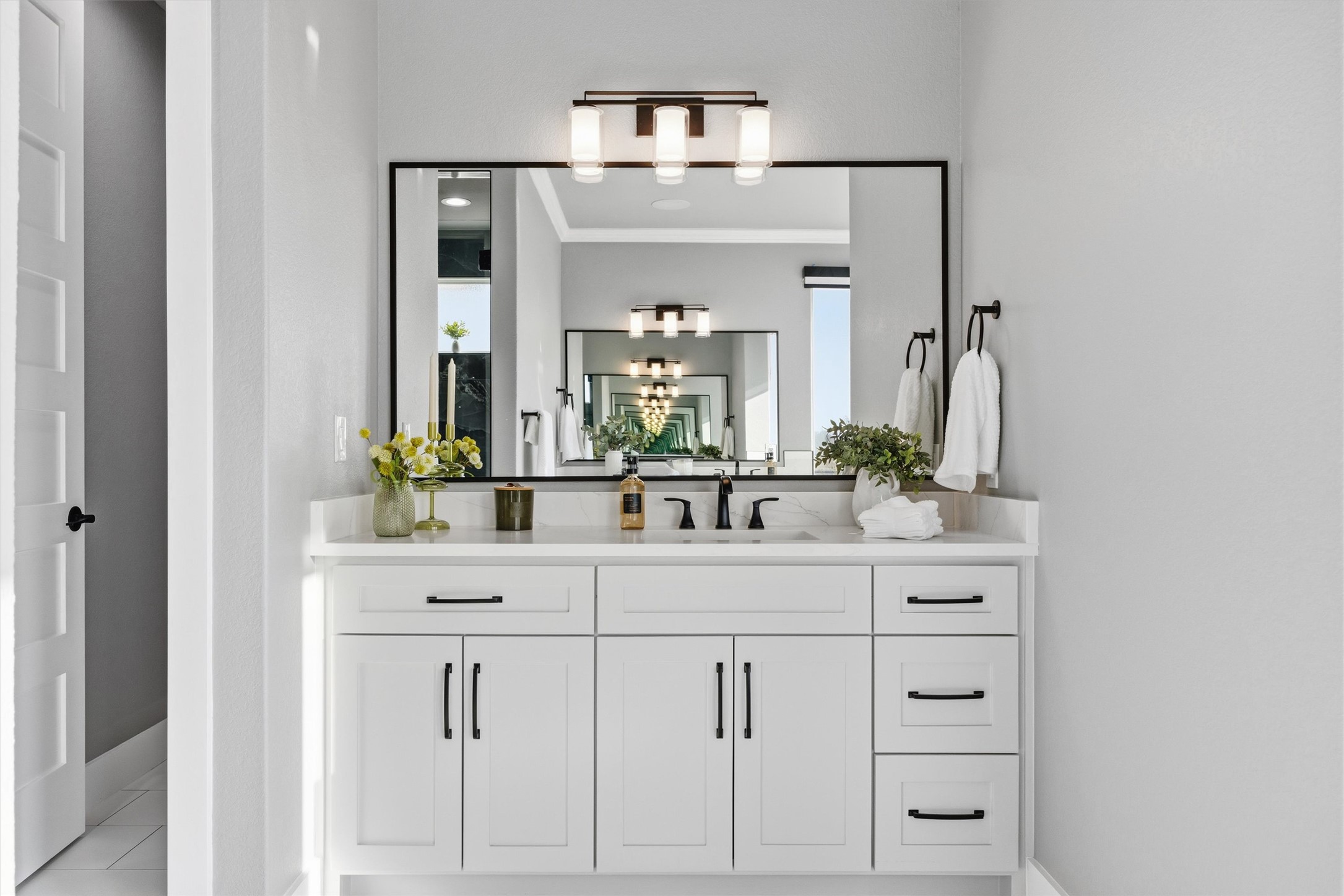 178 Balch Road Elgin, TX 78621 - Photo 16 of 40 a bathroom with white cabinets and a mirror