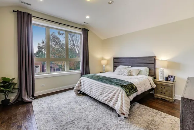 a bedroom with a large bed and a large window