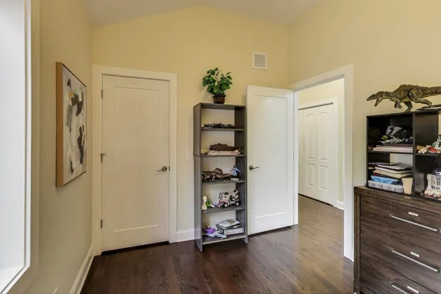 a view of a hallway with wooden floor and closet