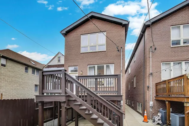 a view of a house with wooden stairs and stairs