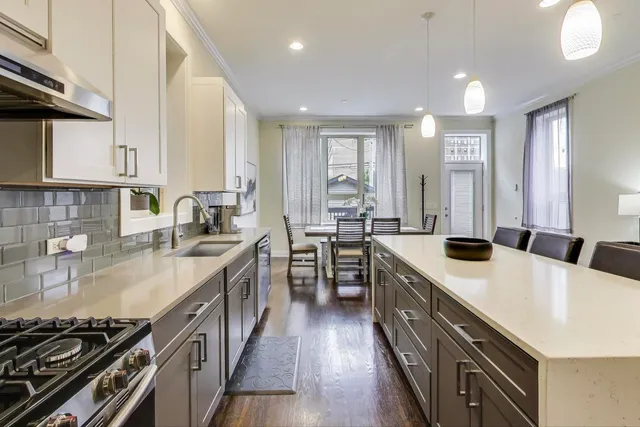 a kitchen with stainless steel appliances sink stove microwave and cabinets
