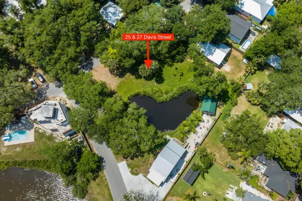 an aerial view of residential house with an outdoor space and seating