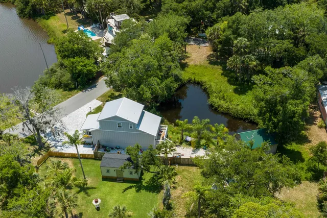 an aerial view of a house with a yard and garden