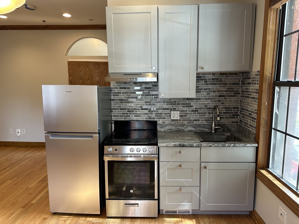 57 Gainsborough Street, Unit 2 Boston, MA 02115 - Photo 2 of 8 a kitchen with a refrigerator sink and cabinets